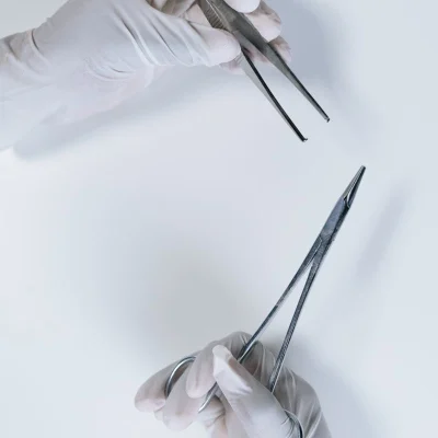 Precision surgical forceps held in surgical setting