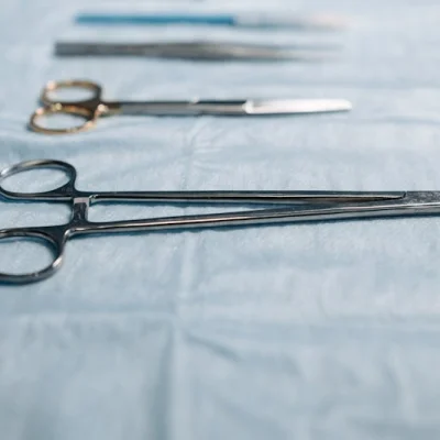 Needle holder surgical instrument on blue cloth
